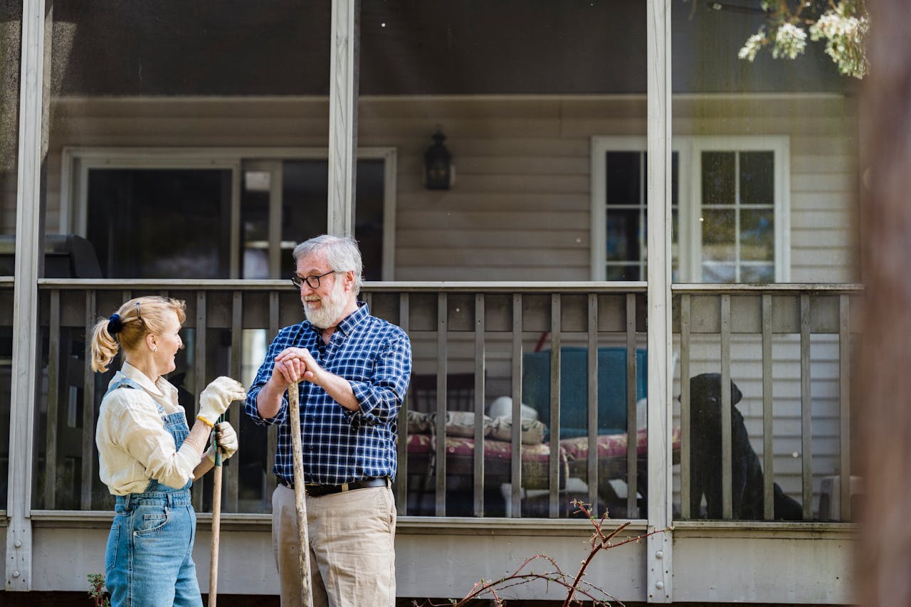 Seniors gardening in front of their home
